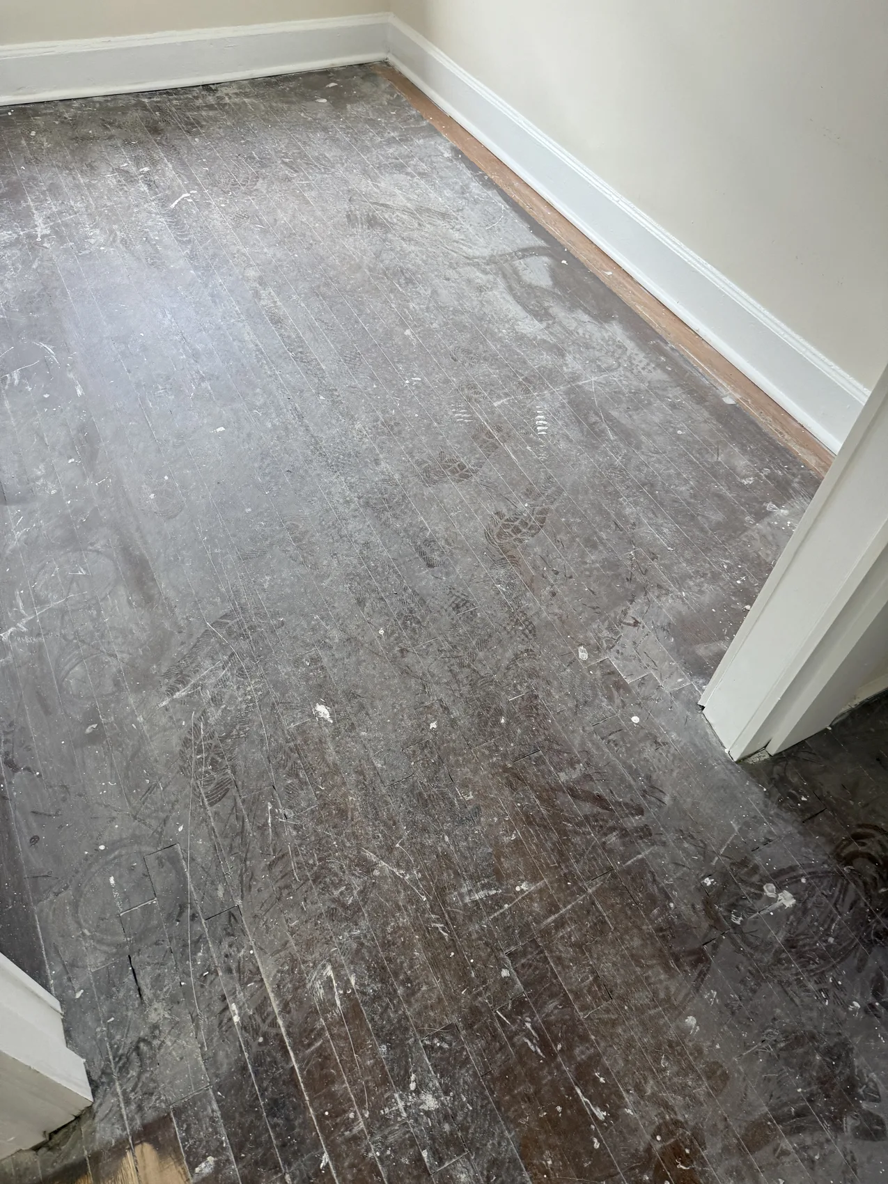 Worn hardwood floor before refinishing